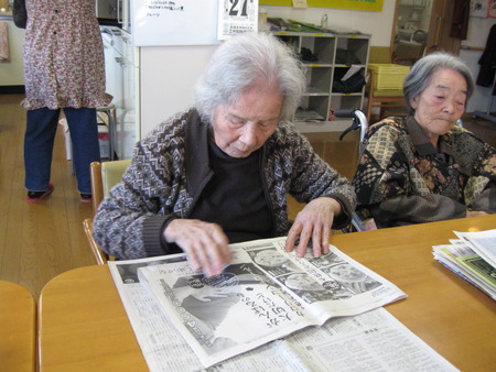 皆さんで排泄介助で使用する新聞をたたんでもらっています
